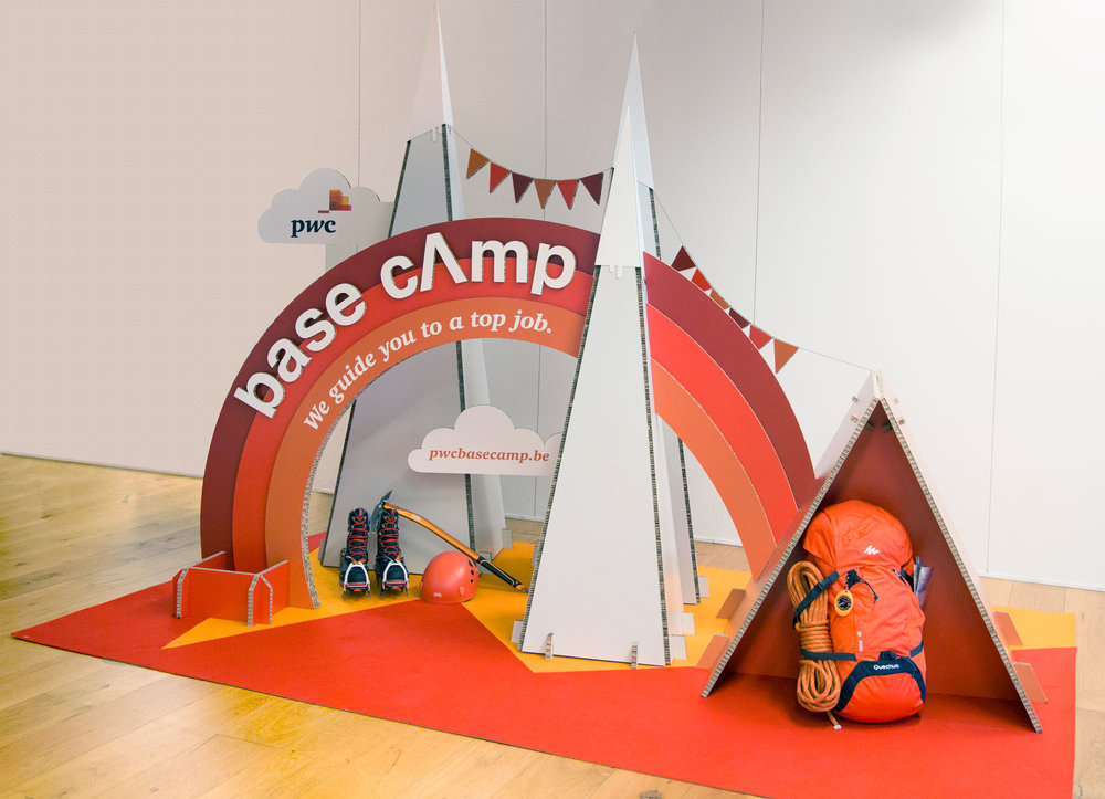 Cardboard representation of Base Camp next to a trekking backpack.