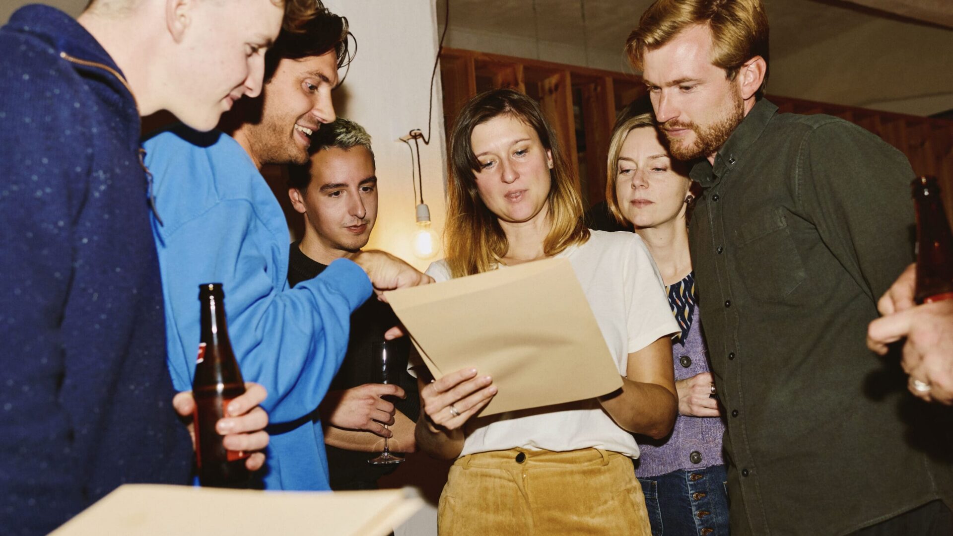 Team members gathered around reviewing packaging design work at an informal presentation