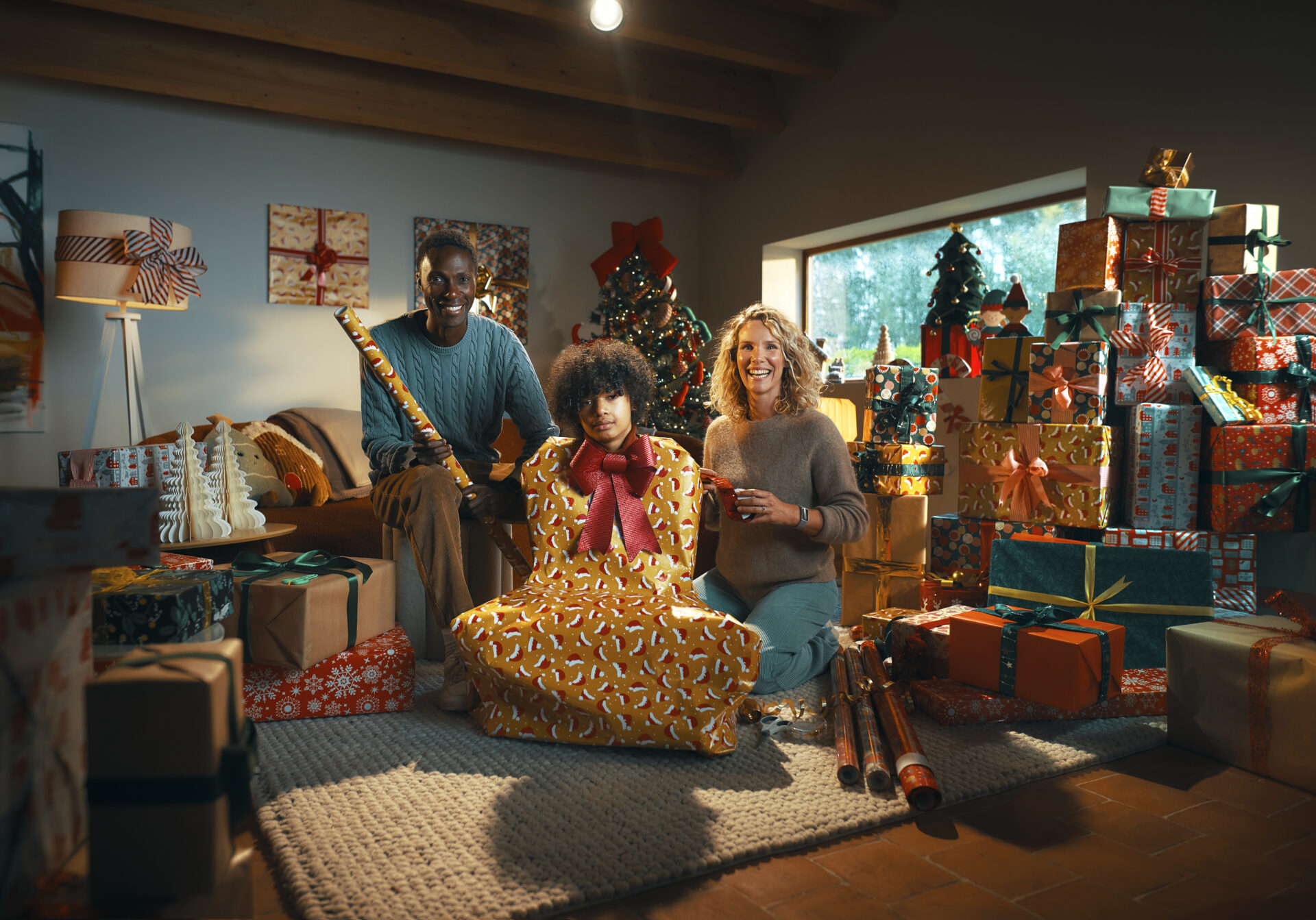 Family sitting in front of a christmas tree.